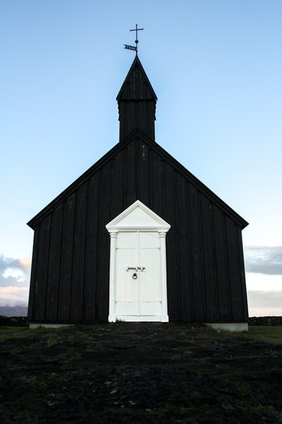 Black and white church under the blue sky
